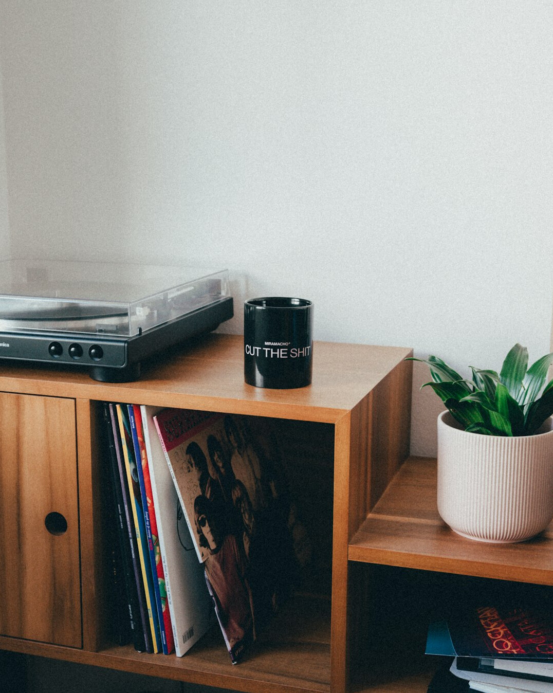 Vintage home office with wooden bookshelves and a record player